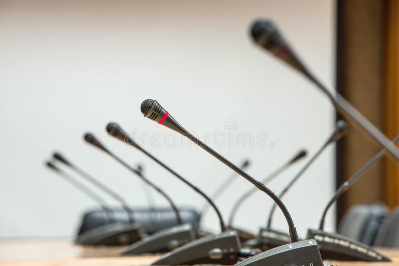 Before a conference, the microphones in front of empty chairs. Selective focus. stock image