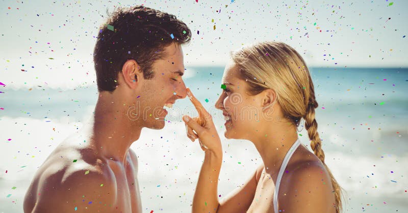 Confetti against couple on beach stock photos Confetti against couple on beach stock photos