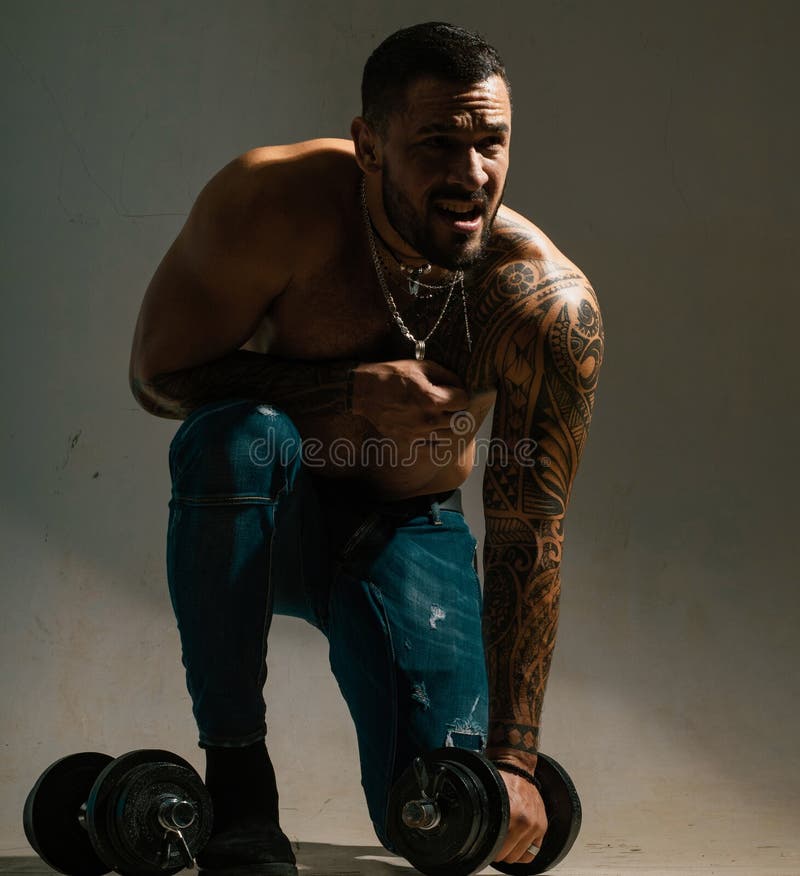 Premium Photo | Healthy young tattoo man standing strong in the gym and  flexing muscles muscular athletic bodybuilder fitness model posing after  exercises