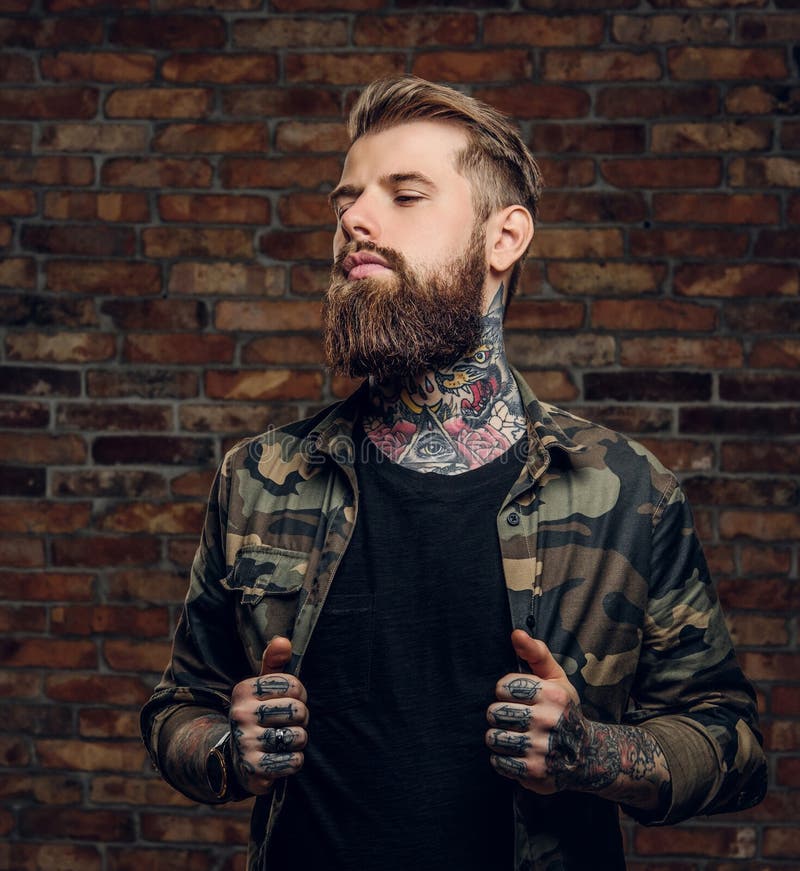 Confident Bearded Guy with Tattoos on His Hands and Neck in the ...