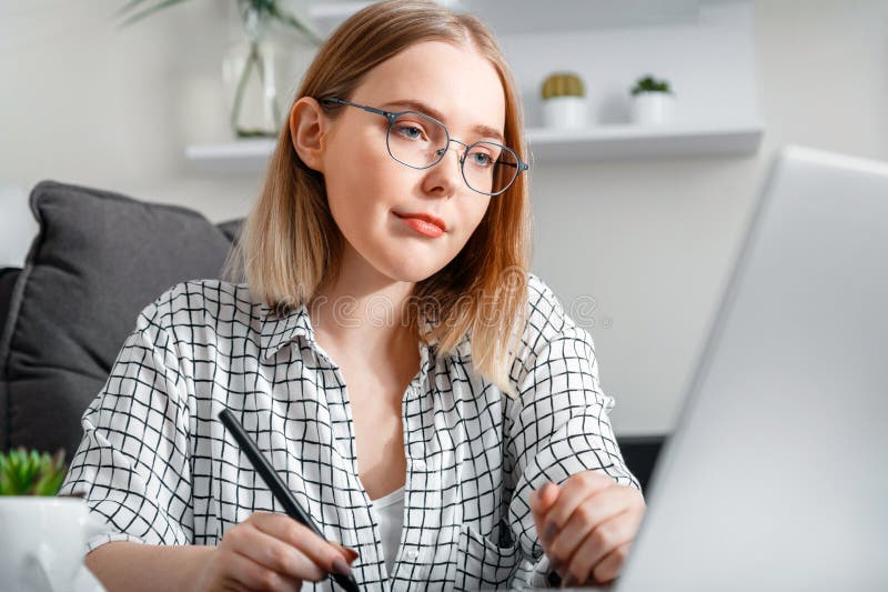 Confident Blonde Woman in Glasses Working Using Laptop while Making