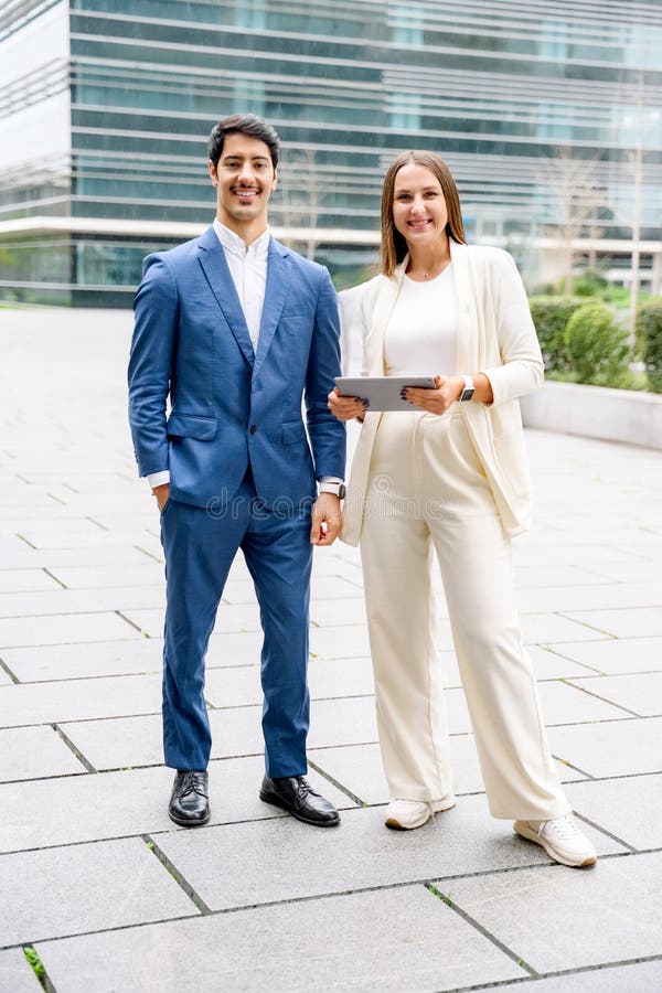 Confident businessman in suit and businesswoman during teamwork stock photo