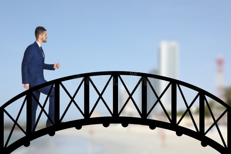 Confident businessman walking over drawn bridge and blurred view of cityscape on background Connection, relationships, support and royalty free stock photo