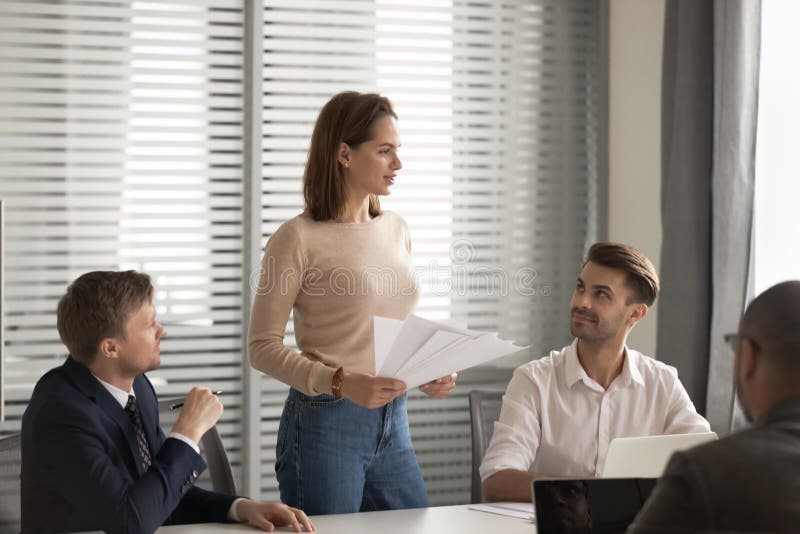 Confident businesswoman holding documents, mentor training staff at briefing stock photography Confident businesswoman holding documents, mentor training staff at briefing stock photography