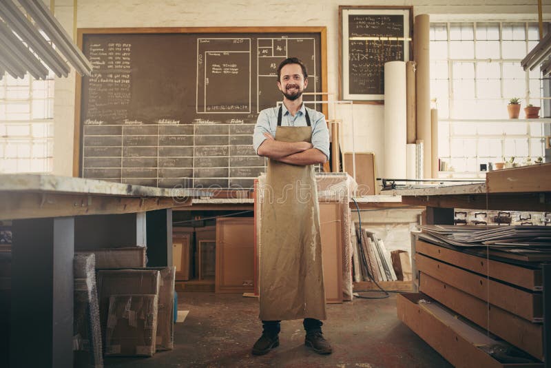 Confident craftsman standing in his workshop studio stock images Confident craftsman standing in his workshop studio stock images