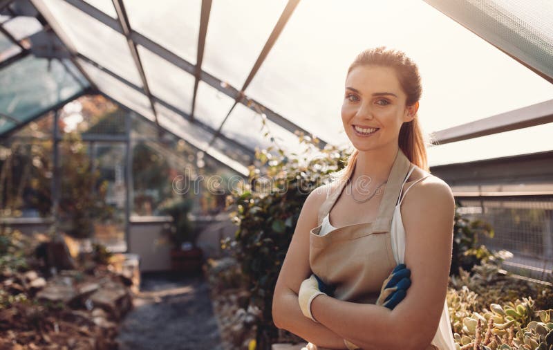 Confident female gardener at plant nursery stock image Confident female gardener at plant nursery stock image