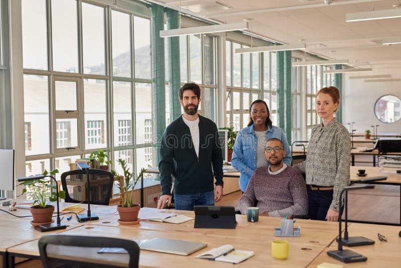 Confident group of young businesspeople working together in an office stock photos