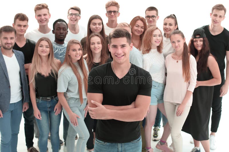 Confident guy standing in front of a group of young people royalty free stock image