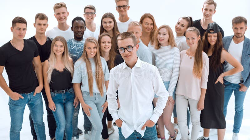 Confident guy standing in front of a group of young people royalty free stock photos