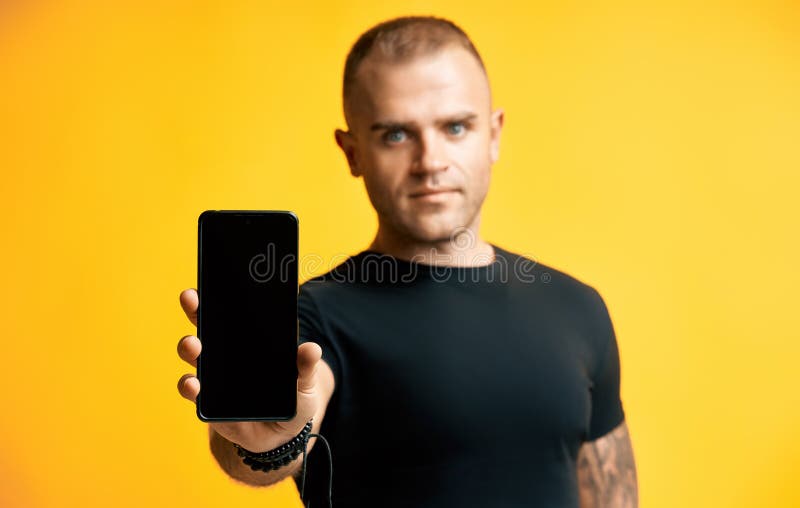 Confident handsome man holding blank screen mobile phone stock images