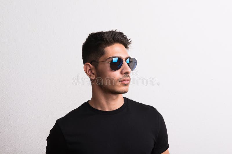 A Confident Hispanic Young Man with Sunglasses and Black T-shirt in a ...