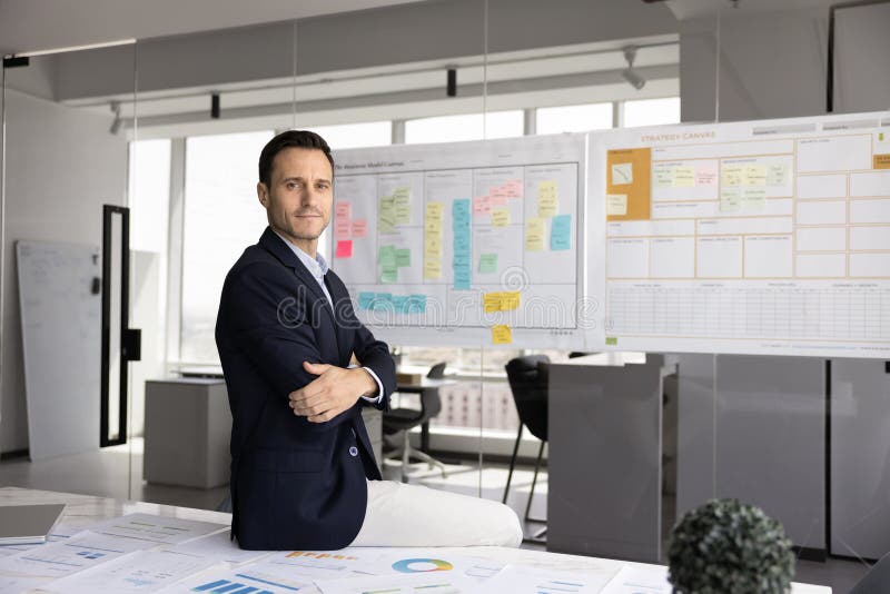 Confident Latin businessman posing for professional portrait at office workplace stock images