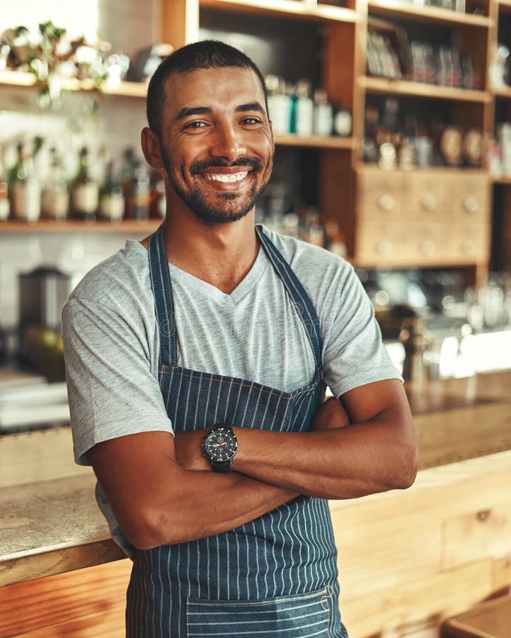 Portrait of Confident Male Barista at Counter in Cafe Stock Image