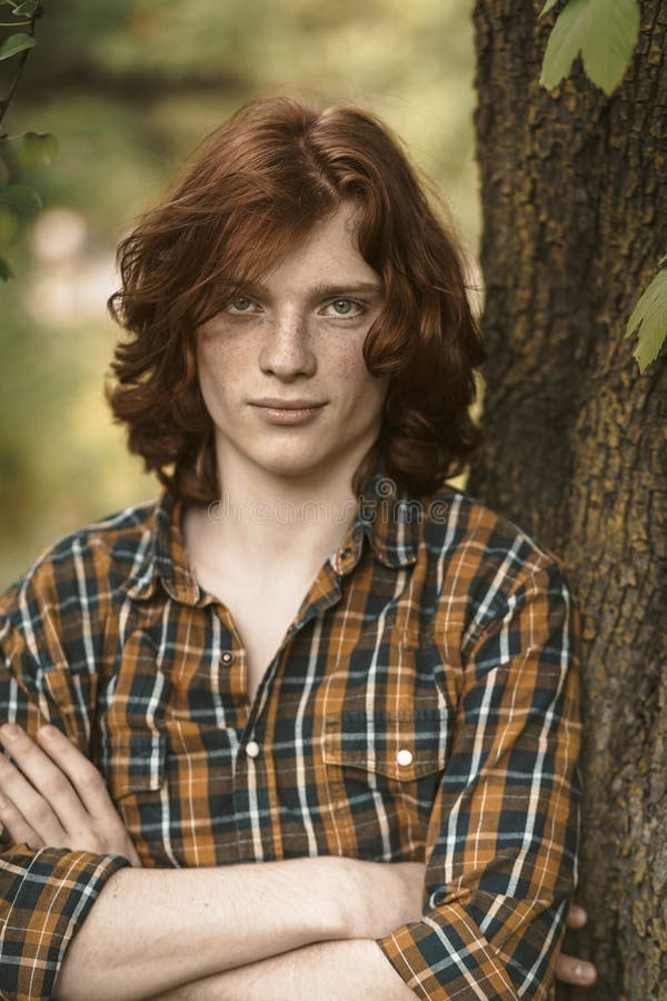 Confident Man with Long Red Hair Stands with Crossed Arms Leaning Against a Tree Trunk. Caucasian Guy Wearing in Stock Image - Image of male, masculine: 186733691 Confident Man with Long Red Hair Stands with Crossed Arms Leaning Against a Tree Trunk. Caucasian Guy Wearing in Stock Image - Image of male, masculine: 186733691