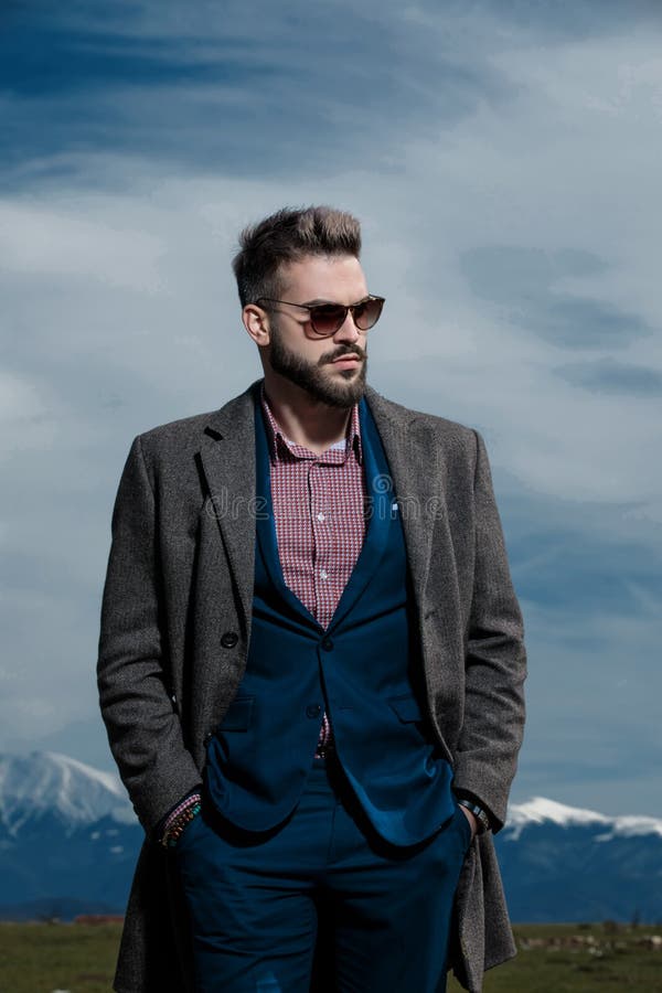 Confident man walking and holding both hands in his pockets royalty free stock image Confident man walking and holding both hands in his pockets royalty free stock image