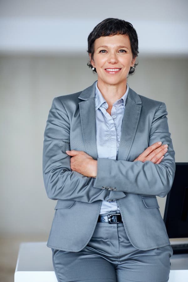 Confident Mature Woman Leaning Against Desk Smiling Mature Business