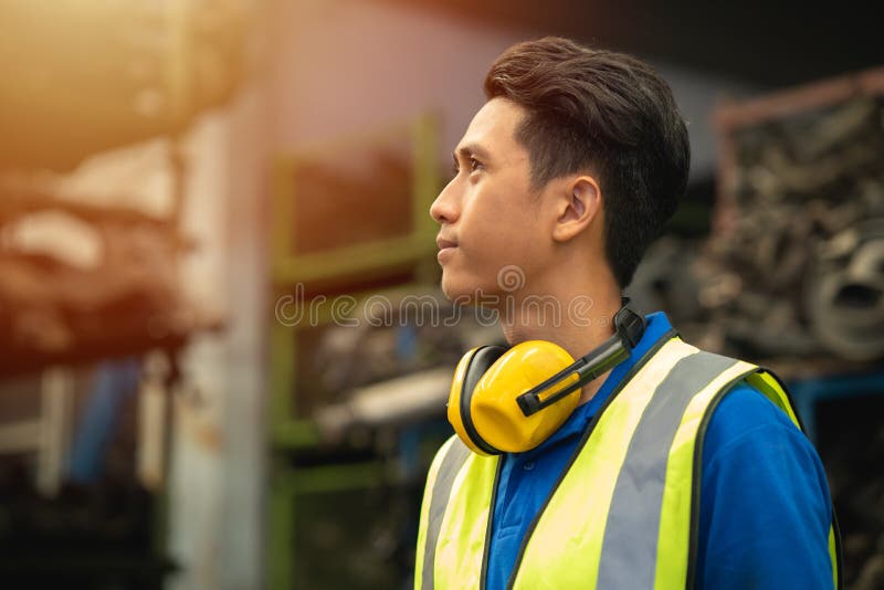 Confident proud Asian male engineer worker standing happy smile for enjoy working in factory royalty free stock images