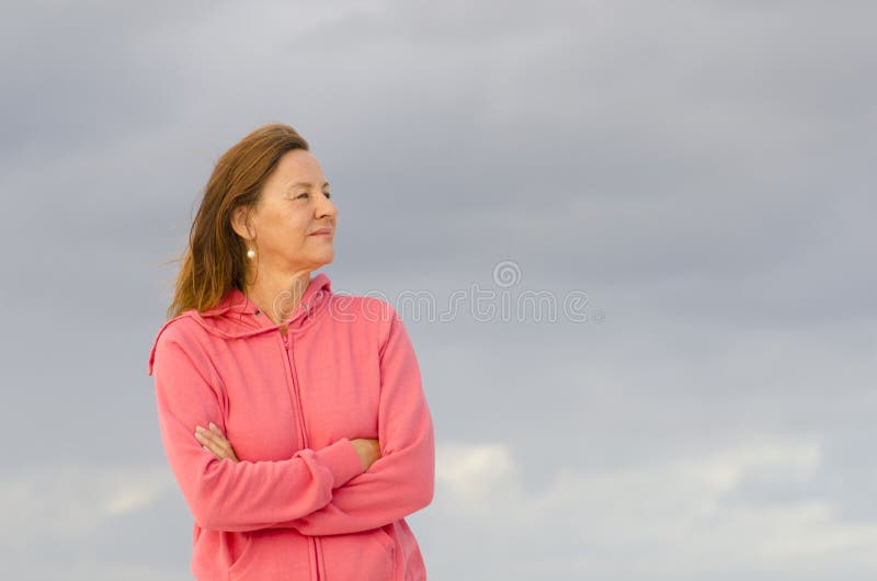 Confident senior woman posing at beach