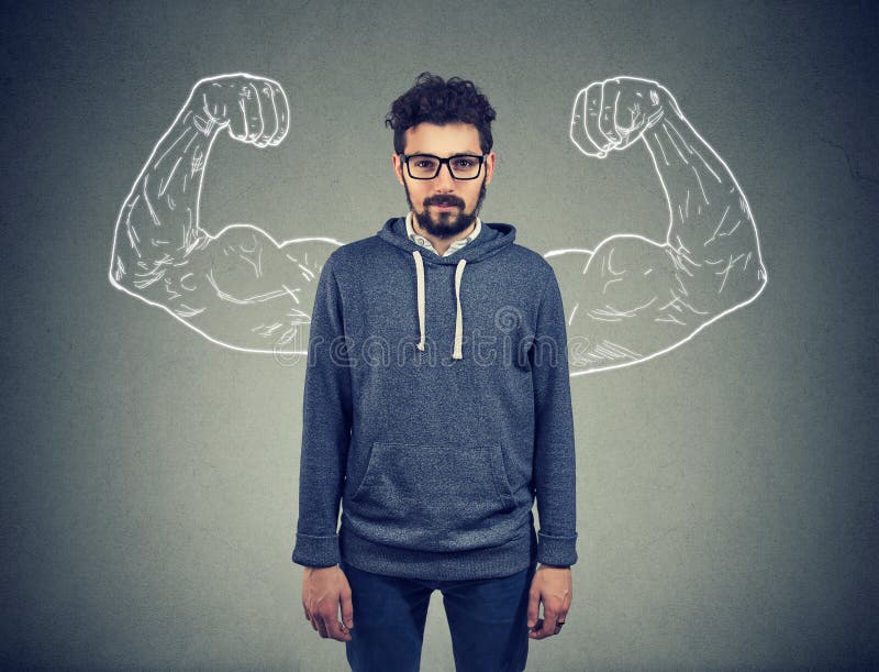 Confident strong man hipster on wall background