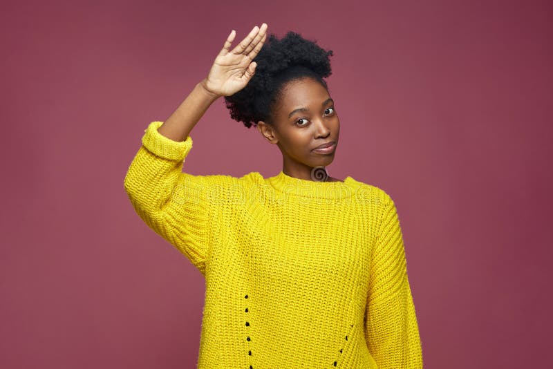 Confident Stylish Young African American Woman with Afro Hair Saluting ...