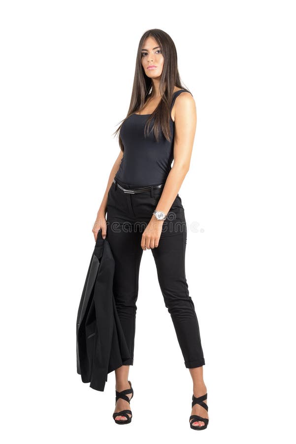 Confident tanned business beauty posing at camera holding her jacket royalty free stock photo Confident tanned business beauty posing at camera holding her jacket royalty free stock photo
