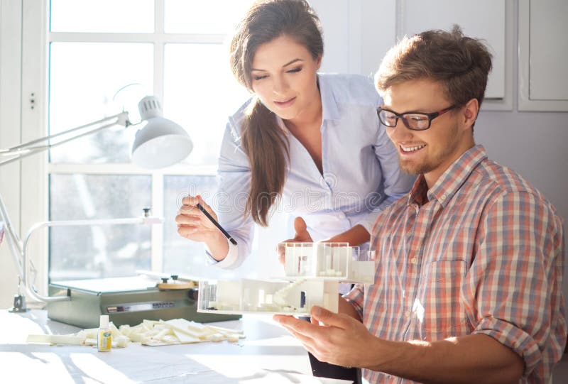 Confident team of engineers working together in a architect studio. stock image