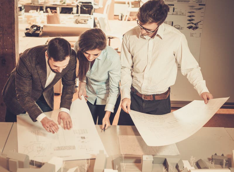 Confident team of engineers working together in a architect studio. stock images