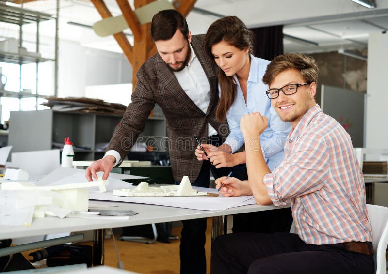 Confident team of engineers working together in a architect studio. royalty free stock photos