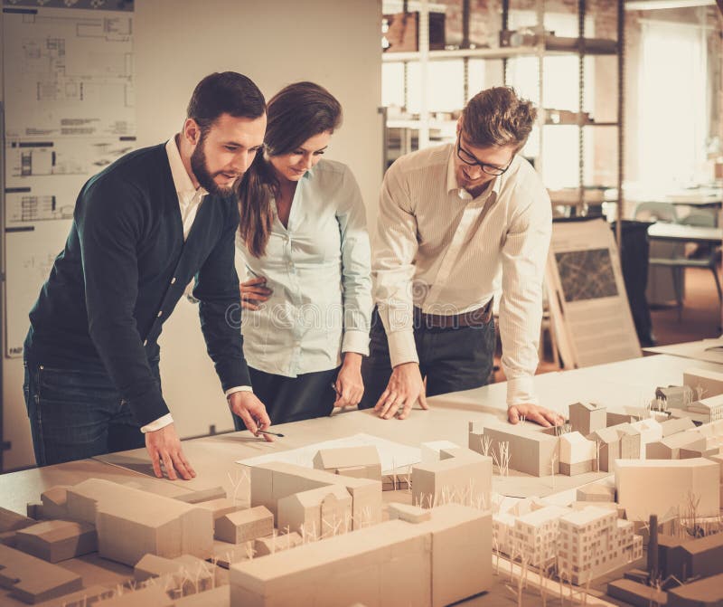 Confident team of engineers working together in a architect studio. stock image