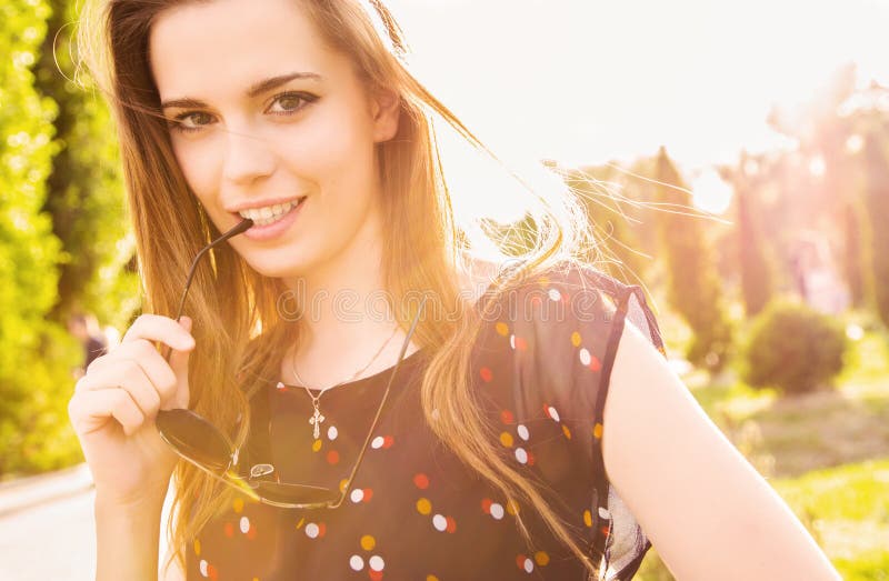 Confident teen girl in sunny outdoor setting