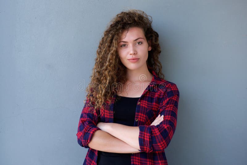 Confident teenage girl standing with arms crossed stock image Confident teenage girl standing with arms crossed stock image