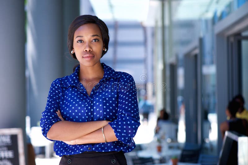 Confident young african american woman standing in the city royalty free stock photo