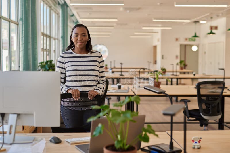 Confident Young African Businesswoman Standing by Her Desk in an Office ...