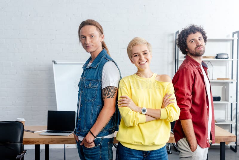 confident young business people standing together and smiling at camera royalty free stock photo confident young business people standing together and smiling at camera royalty free stock photo