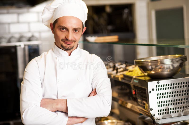 Confident young chef posing stock images