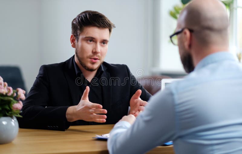 Confident young man attending job interview