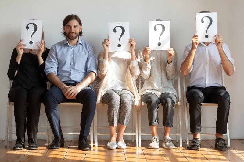 Confident young man sitting on chair in queue of unknown people. stock photography Confident young man sitting on chair in queue of unknown people. stock photography