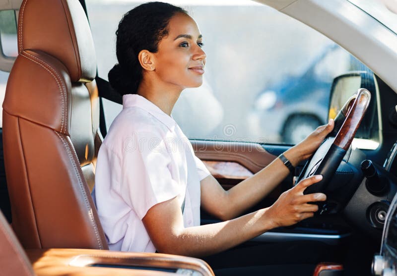 Confident young woman driving car stock photo Confident young woman driving car stock photo
