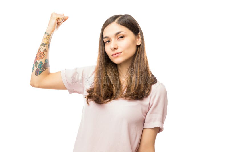 Confident Young Woman Flexing Her Biceps royalty free stock image Confident Young Woman Flexing Her Biceps royalty free stock image