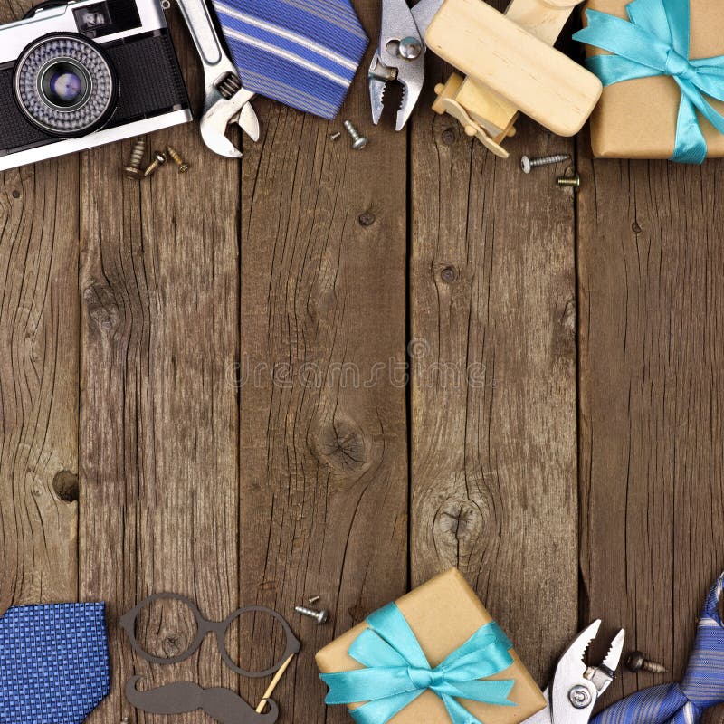 Fathers Day theme double border of gifts, ties and tools on a rustic wood background. Top view with copy space. Fathers Day theme double border of gifts, ties and tools on a rustic wood background. Top view with copy space.