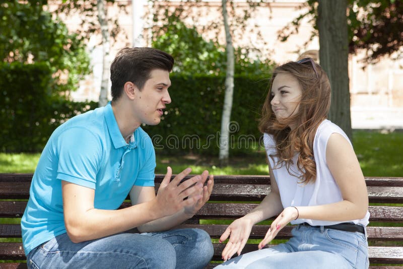 Conflicted couple not talking to each other seated on a wooden bench in park stock photography Conflicted couple not talking to each other seated on a wooden bench in park stock photography