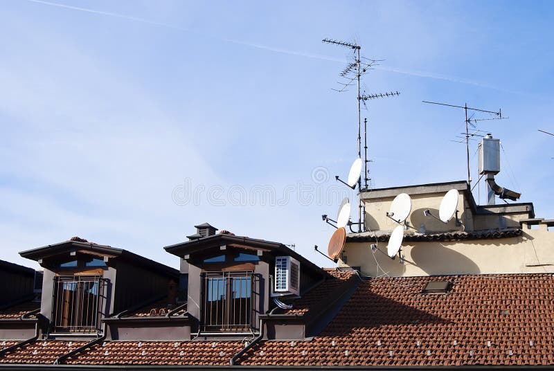 Television satellite dishes on the roof of an old building. Television satellite dishes on the roof of an old building