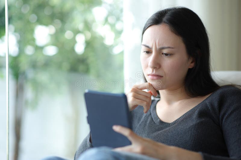 Confused asian woman reading ebook stock photos