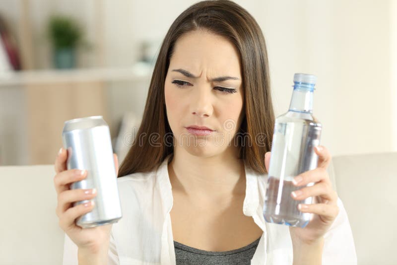 Confused girl deciding between soda refreshment and water