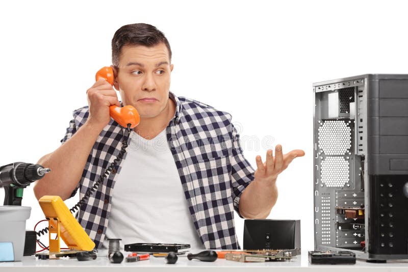 Confused PC technician talking on phone stock photo