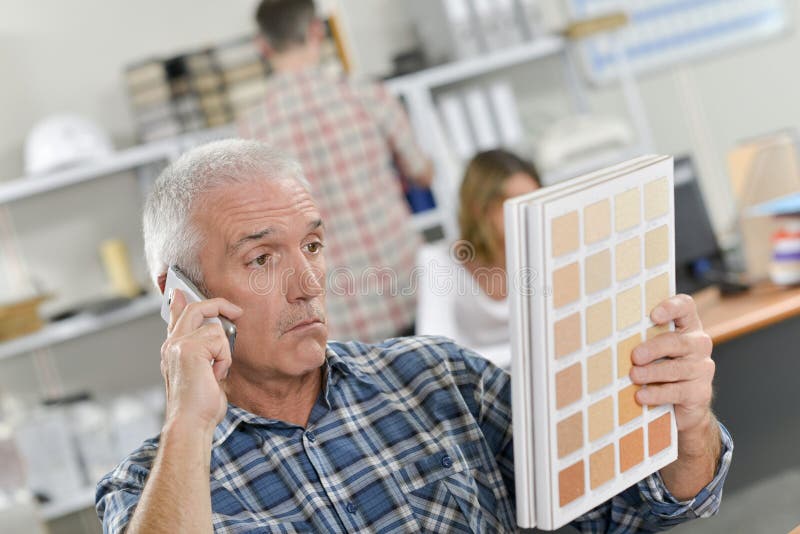 Confused senior office worker on phone royalty free stock photo