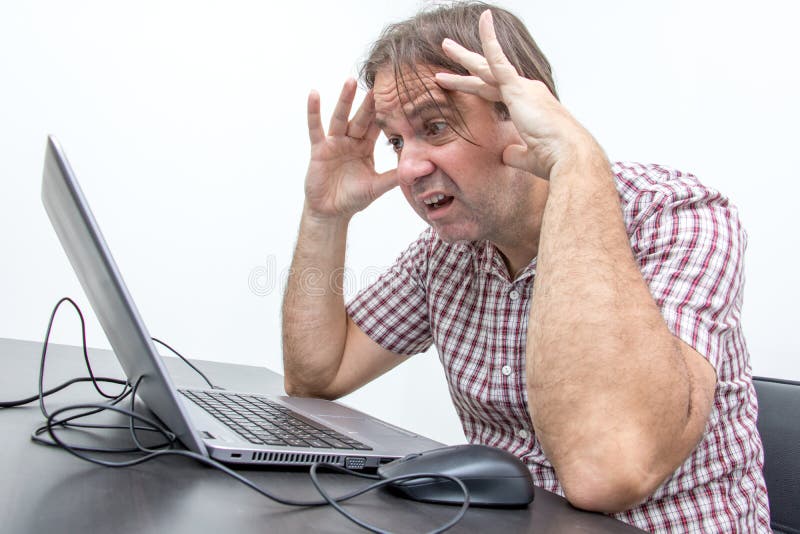 The confused unhappy user is looking at the computer stock image The confused unhappy user is looking at the computer stock image