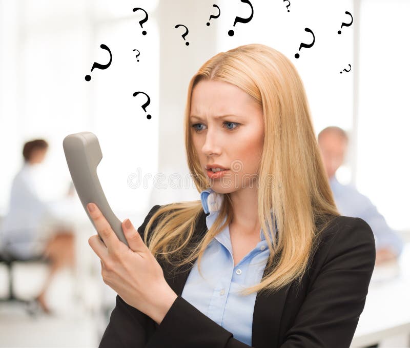 Confused woman with phone in office
