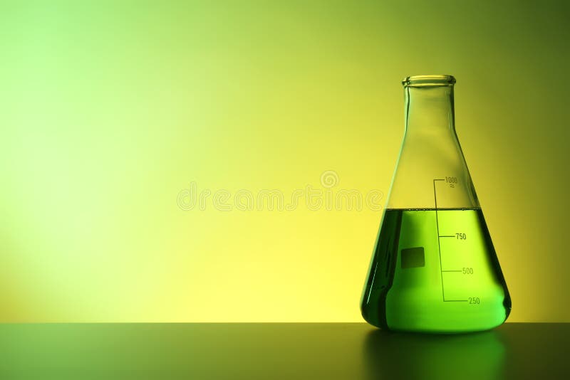 Conical flask with liquid on table against color background royalty free stock image