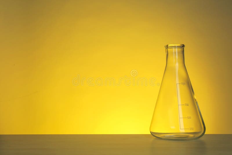 Conical flask with liquid on table against color background royalty free stock images